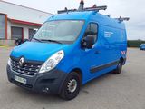 La camionnette bleue est garée sur un parking près d'un immeuble.