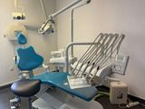 a dentist ' s chair in the corner of the room