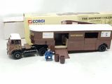 a toy truck with a man standing in front of it