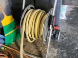 hoses and hoses are stacked on a cart in a garage