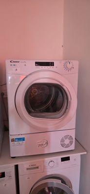 two washers and a dryer stacked on top of each other