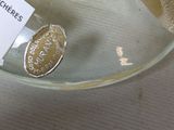 a banana in a glass bowl with a label on it