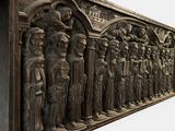 a sculpture of a group of people standing in front of a building