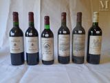 several bottles of wine are lined up on a table