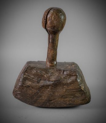 a close up of a wooden object on a white surface