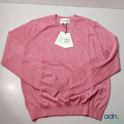 a close up of a pink sweater with a tag on it