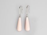 a pair of pink stone earrings on a grey background