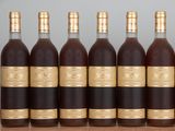 six bottles of wine lined up in a row on a table