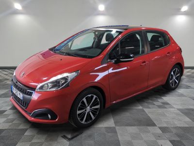 a red car parked in a garage with a checkered floor