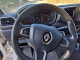 a steering wheel and dashboard of a car in a parking lot