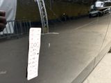 a sticker on the door of a car that is parked on the side of the road