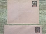 three envelopes are sitting on a wooden surface with stamps on them