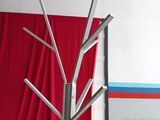 a metal tree that is sitting on a pink table
