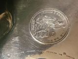 a silver coin sitting on top of a piece of paper