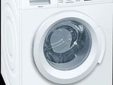 a white washing machine sitting on a black background