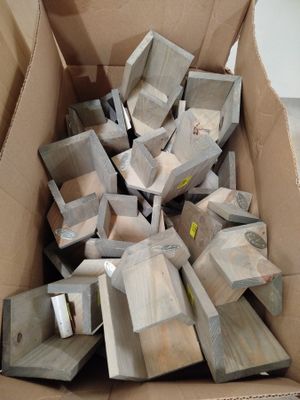 a cardboard box full of wood pieces in a room