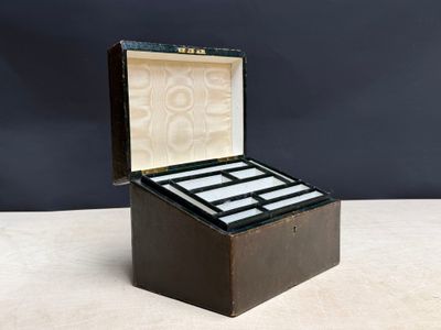 an old wooden box with four cards inside on a table