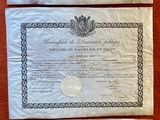 three certificates on a table with a red table cloth
