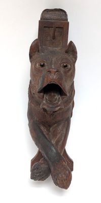 an image of a statue of a bear with a knife in its mouth