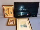 three framed pictures of birds and a boat on a table