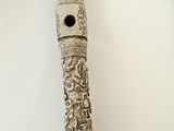 a flute that is sitting on a white table