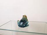 a glass table with a glass frog on top of it
