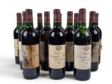 six bottles of wine are lined up on a white surface