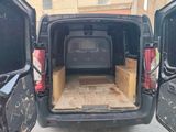 the back of a van with the door open and the back of the van with the door open