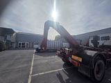 a truck with a crane on the back of it in a parking lot