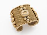 an image of a gold cuff bracelet with beads on it