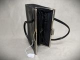 a black purse that has a tag on it