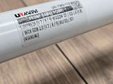 a close up of a tube of toothpaste on a wooden table