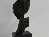 statue of a woman with a hat on her head and a hand on her hip