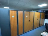 a row of wooden lockers in the middle of a room