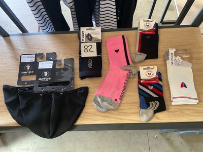 several pairs of socks, socks, a wallet, a wallet, and other items are sitting on a table