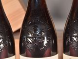 three bottles of wine that are sitting on a table