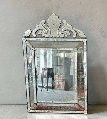 a mirror sitting on a table with a chair in the background