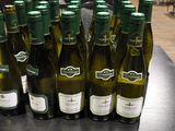 bottles of wine are lined up on a table in a restaurant
