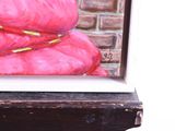 a painting of a stack of pink pillows on a window sill