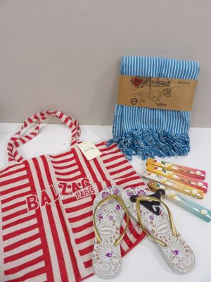 towels, flip flops, and a towel are laid out on a table