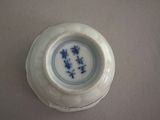 a small white bowl with blue flowers on it