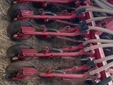 a red plow that is laying on the ground