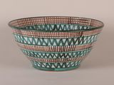 a blue and brown bowl sitting on a white surface