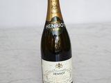 the bottle of champagne is sitting on a marble counter top
