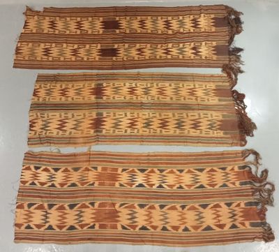 three pieces of cloth with different designs on them