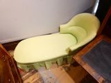 a green chair that is sitting in a room