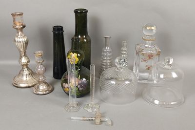 many different types of glass bottles and vases on the table