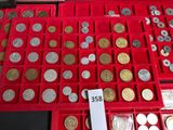 a lot of coins in a red box on a table