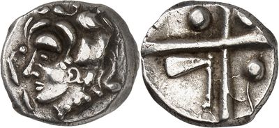 a close up of a coin with a cross on it
