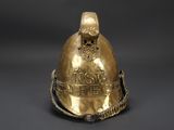 an old fireman ' s helmet with a chain around the neck